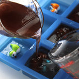 Pouring mica colored soap for the second layer of handmade soap